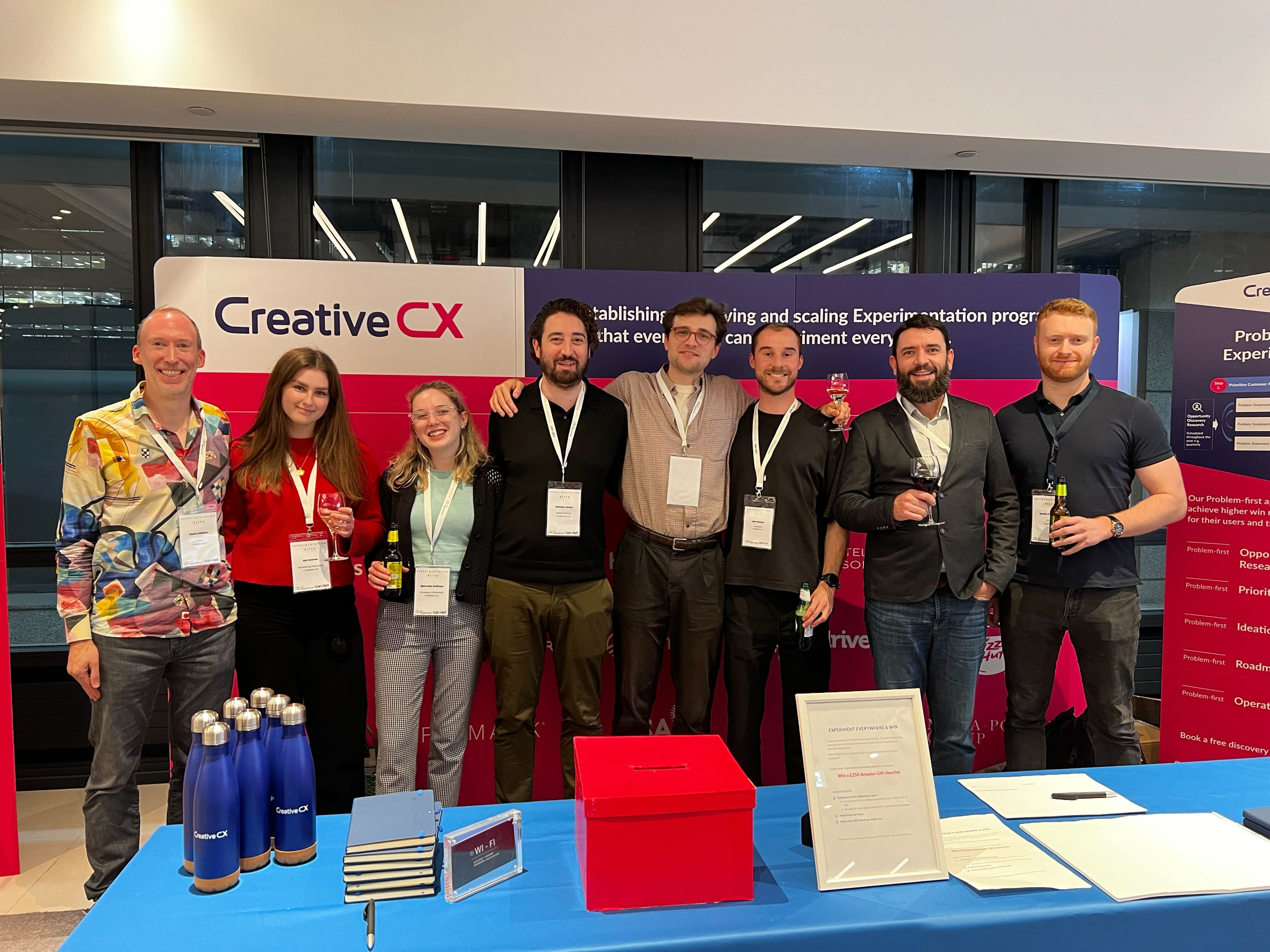 The Creative CX team in front of our stands and pop-ups at Experimentation Elite