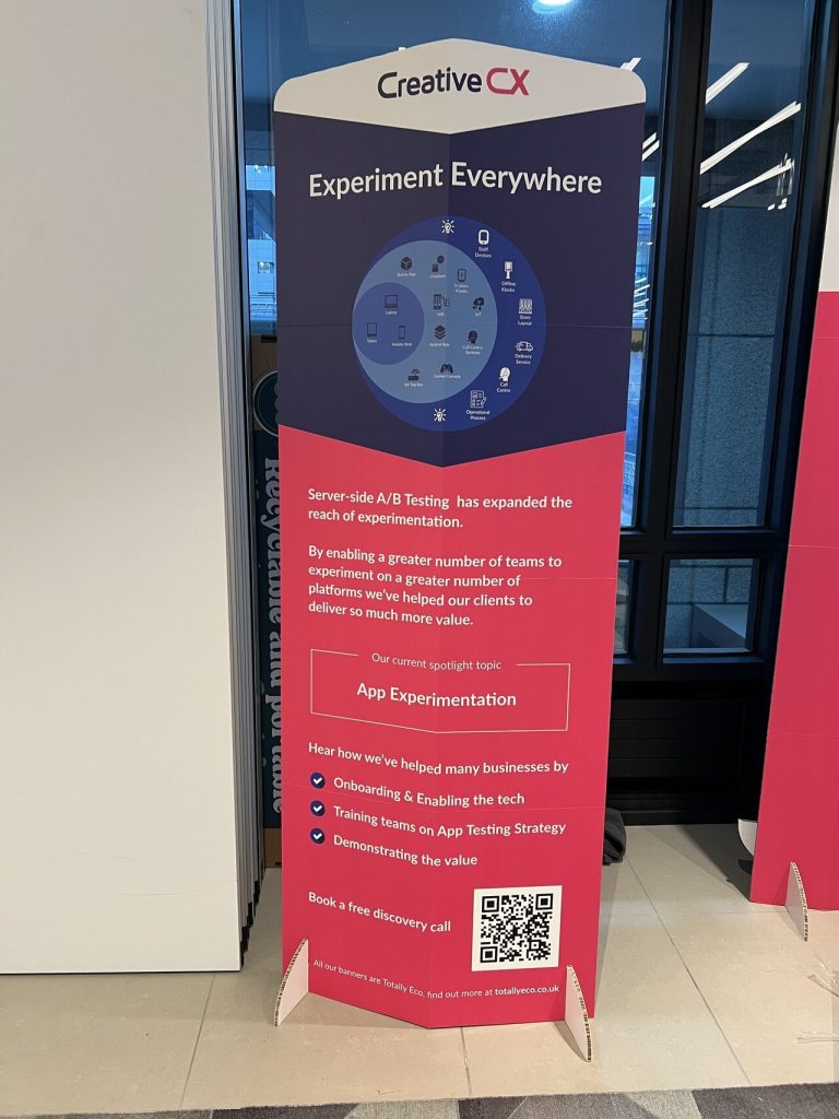 Our pop-up banner from the conference 'Experiment Everywhere' explains how server-side A/B testing has expanded the reach of experimentation, enabling more teams to experiment across various platforms. It features a circular diagram of devices and mentions the spotlight topic, 'App Experimentation,' along with details on onboarding, training, and demonstrating value. A QR code at the bottom links to more information.